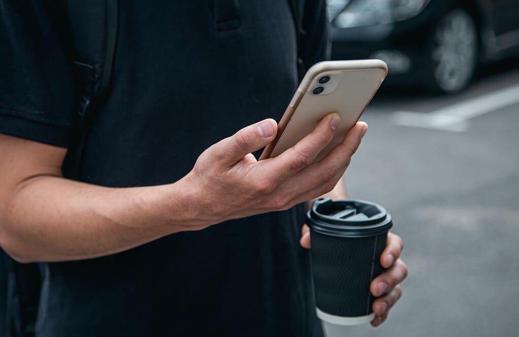 melbet - person - using - app - on - mobile - phone